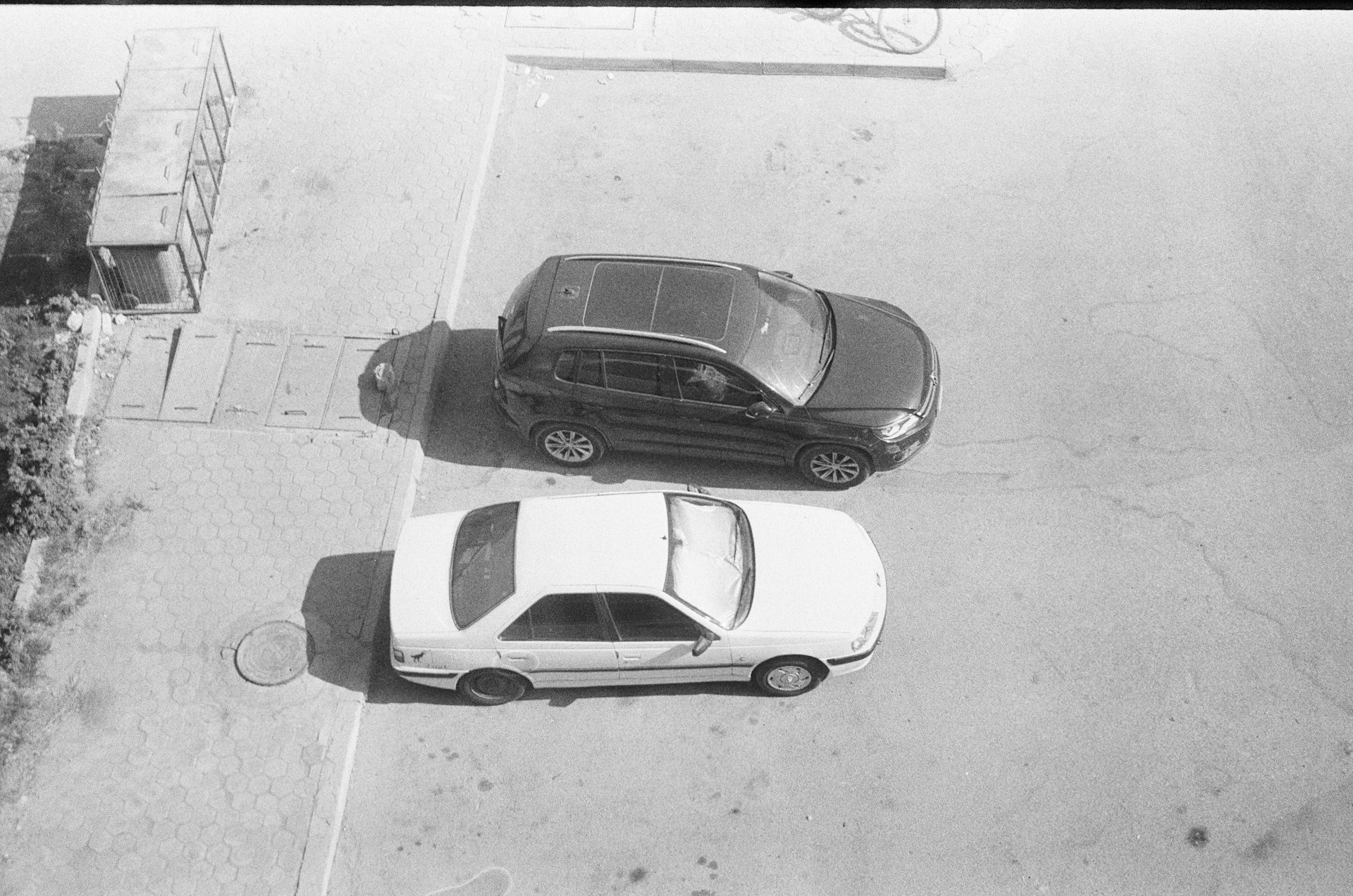 Two cars parked on a paved surface.